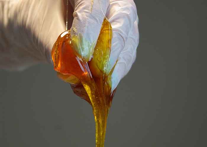 Sugaring hair removal - a hand holding the sugaring paste